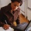 Woman taking notes while working on her laptop.